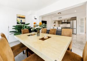 a dining room and living room with a table and chairs at Unique Villa Scandinavia Marbella in Marbella