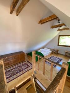 an attic room with a bed and a couch at Căsuța Anei in Rîmeţi-Valea Inzelului +26 photos