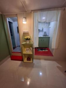 a room with a kitchen with a table and a sink at GD's Homestay in Shillong +5 photos