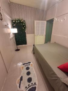 a bedroom with a bed with a panda blanket on the floor at GD's Homestay in Shillong