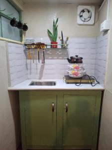 a kitchen with a sink and a counter top at GD's Homestay in Shillong