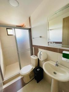 a bathroom with a shower and a toilet and a sink at hotel boutique in Pereira +25 photos