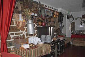 a kitchen with a table with plates on it at Hotel La Belle Aude in Matemale