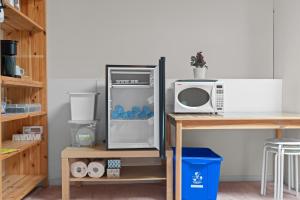 a kitchen with a refrigerator and a microwave at Home Base Quiet Queen Rooms in Richmond