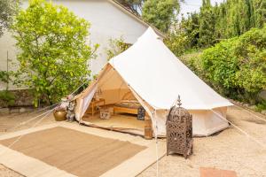a white tent in a yard next to a house at Villa Can Gavarres in Bell-Lloch