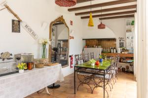 a kitchen and dining room with a table and chairs at Villa Can Gavarres in Bell-Lloch