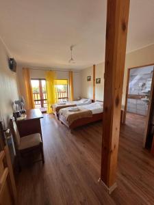 a large room with two beds and a desk at U Górala in Cieszków