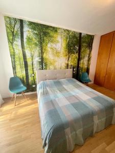 a bedroom with a bed and a large window with trees at Fabio's Home in Bassano del Grappa