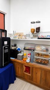 a counter with a display case with donuts on it at B&B AlMare in Vieste