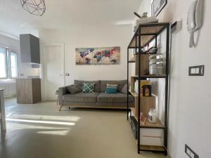 a living room with a couch and a shelf at Fabio's Home in Bassano del Grappa