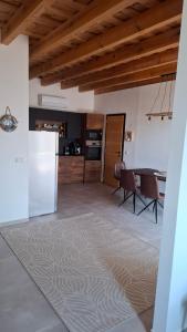 a kitchen and dining room with a table and chairs at Mirtusz Apartmanház in Balatongyörök +25 photos