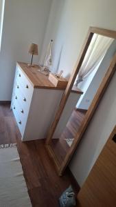 a mirror sitting on top of a dresser in a room at Mirtusz Apartmanház in Balatongyörök