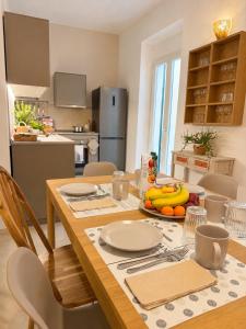 a kitchen with a table with bananas and fruit on it at Giada Apartments in Moneglia