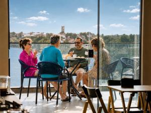 a group of people sitting at a table in a restaurant at Bella Vista Hotel in Barreirinhas