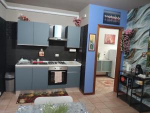 a kitchen with a sink and a stove at Casa Maria 3 in Cigole