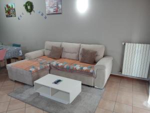 a living room with a couch and a coffee table at Casa Maria 3 in Cigole