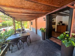 a patio with wooden tables and chairs and plants at Tamahuche Hotel Rural in Vallehermoso