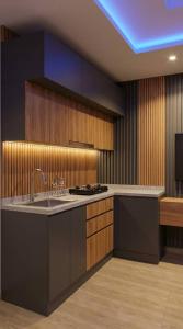 a kitchen with a sink and a counter top at The Royam Hotel and Apartments in Ibadan