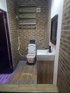 a small bathroom with a toilet and a sink at The Royam Hotel and Apartments in Ibadan +5 photos