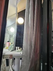 a bathroom with a sink and a mirror at Bulevard Stefan 64#11 Chill Hotel in Chişinău
