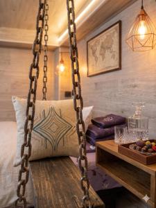a wooden swing in a room with a table at Bulevard Stefan 64#11 Chill Hotel in Chişinău