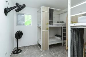 a room with bunk beds and a fan at Casa Ecotrips Barra Funda - Hostel in São Paulo