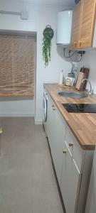 a kitchen with a sink and a washing machine at Casa Manito in El Barraco +6 photos
