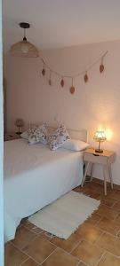 a bedroom with a bed and a table with a lamp at Casa Manito in El Barraco