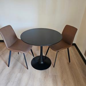 two chairs and a table and a table and chairs at The Coolin Motel in Coolin