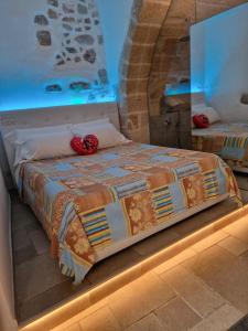a bedroom with a bed in a room with a mirror at Il Fico Luxury Suite & SPA in Polignano a Mare