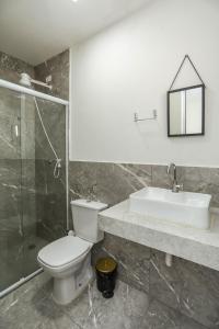 a bathroom with a toilet and a sink and a shower at Casa Ecotrips Barra Funda - Hostel in São Paulo +75 photos