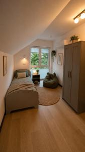 a bedroom with a bed and a large window at DARESTATE - dom rodzinny in Zgon +7 photos