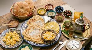 a wooden table topped with plates of breakfast foods at Desert Stars Oasis in Aoufous