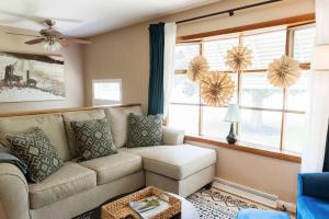 a living room with a couch and a window at Family Friendly Getaway with Fire Pit & Swing Set in Geneva