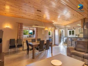 a dining room and living room with a table and chairs at Casa Bon Nadal in Llucmajor