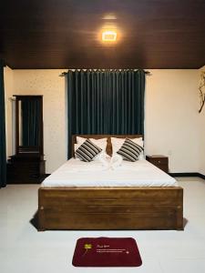 a bedroom with a large bed with two pillows at Airport Kiyas Transit Villa Free Airport Pickup or Drop in Katunayaka