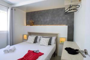 a bedroom with a bed with two towels on it at Tamarit Beach Resort in Tarragona