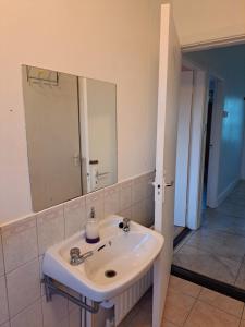 a white sink in a bathroom with a mirror at Sunrise House in Cahersiveen +7 photos