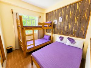 a room with two beds and a bunk bed at 3 Mins Drive to Marlboro Hills - Sagada Dad's Homestay in Sagada