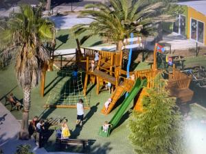 an aerial view of a playground with palm trees at Mobilhome au Camping La Yole in Vendres