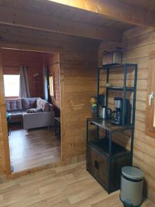 a living room with wooden walls and wooden floors at Ferienhaus Mit Blick auf die Müritz in Rechlin