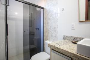 a bathroom with a shower and a toilet and a sink at POUSADA JURERE in Florianópolis +67 photos
