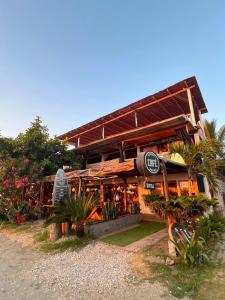 a building with a sign on the side of it at Las Olas del Surf in Ayampe