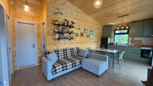 a living room with a couch and a table at Tianeti Apple Cottages in Churchelaurebi