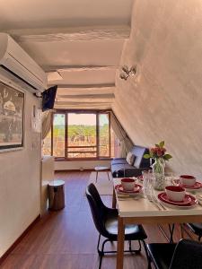 a living room with a table and chairs and a couch at FRANRÉAL, 4 Appartements Climatisés in Sarlat-la-Canéda
