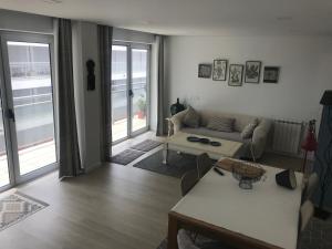 a living room with a couch and a table at HabiKuchta Foz in Figueira da Foz