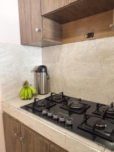 a kitchen with a stove top with bananas on it at Cabaña Kokkos Del Mar in Santa Marta +13 photos