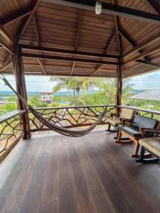 a hammock on the deck of a beach house at Casa vacacional Tena Archidona in Tena