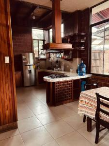 a kitchen with a stainless steel refrigerator and a table at Casa vacacional Tena Archidona in Tena