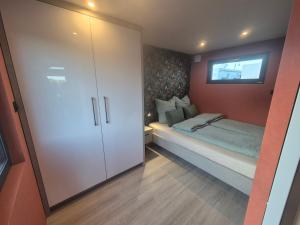 a small bedroom with a bed and a closet at Eifelchalet Mendig in Mendig